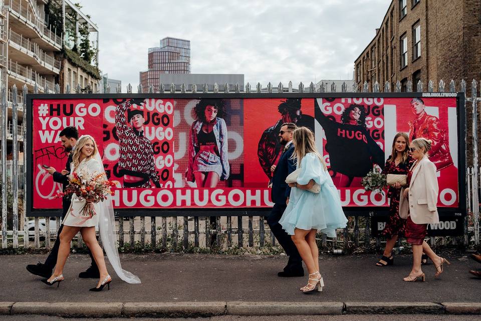 A wedding party walking down a street in the UK