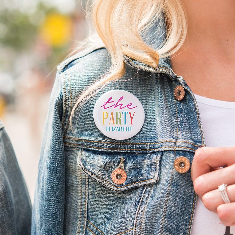 Girl wearing a badge that says the party Elizabeth