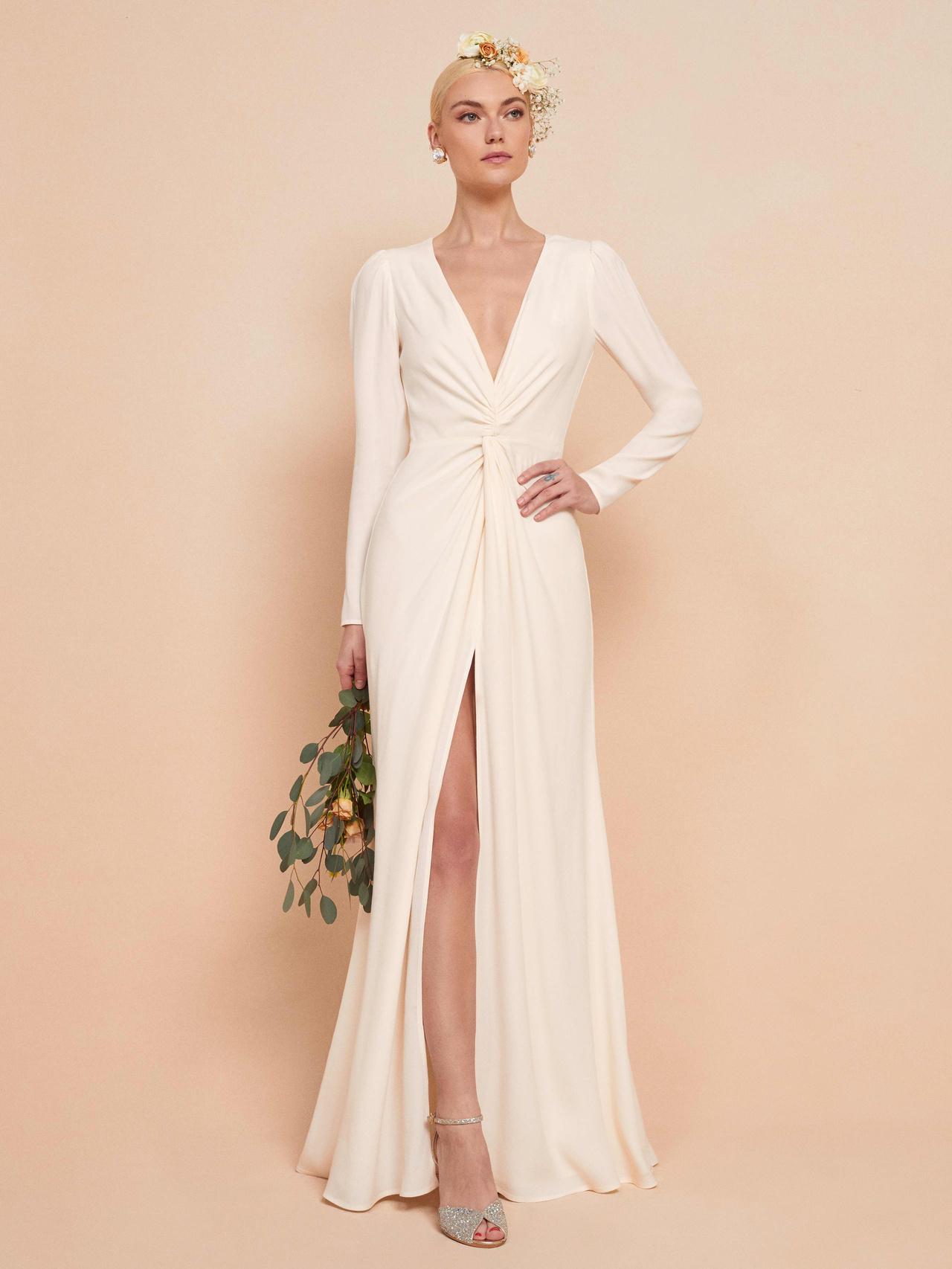 Model wearing a long sleeved sleek garden wedding dress