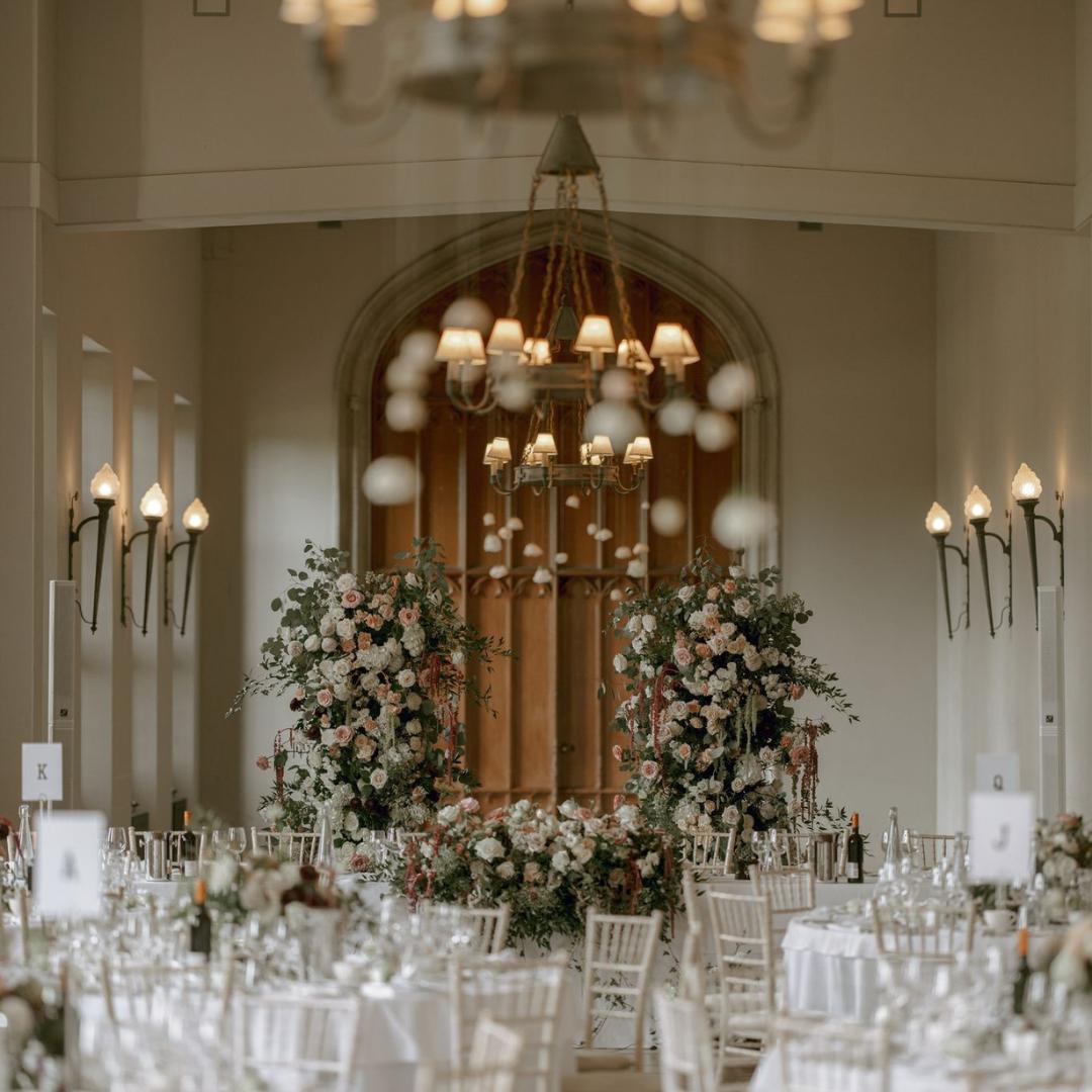 U-shaped pastel pink and white flower arch at wedding.