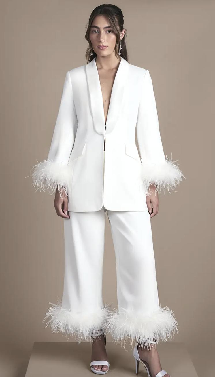 matching white blazer and trousers trimmed with white feathers