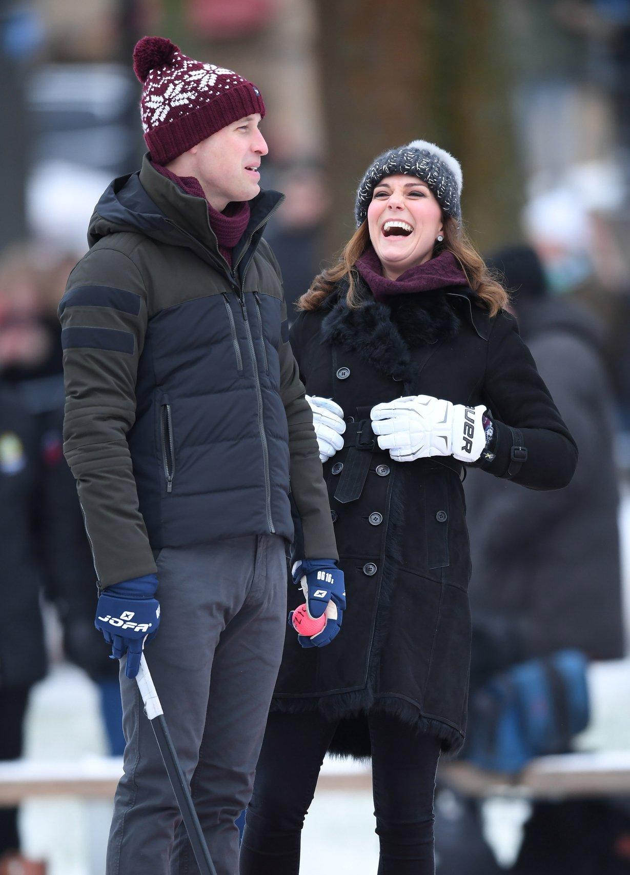 Kate Middleton and Prince William stand on an icerink
