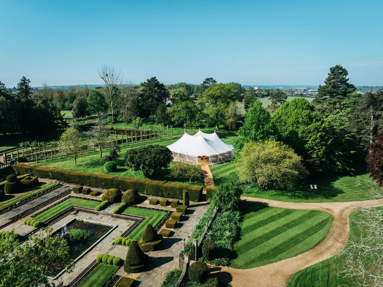 Immaculately groomed grounds surrounding marquee at Fanhams Hall, Hertfordshire.