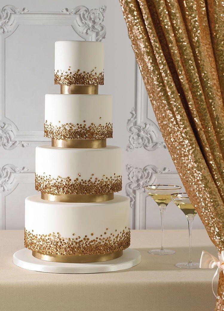 white wedding cake with gold sequins cascading up each tier