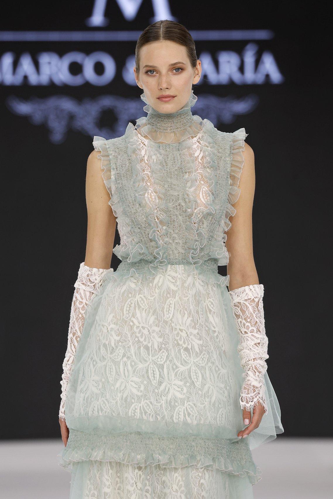 Marco y Maria at Barcelona Bridal Week 2026, model wearing lace gathered gloves and a lacey wedding dress