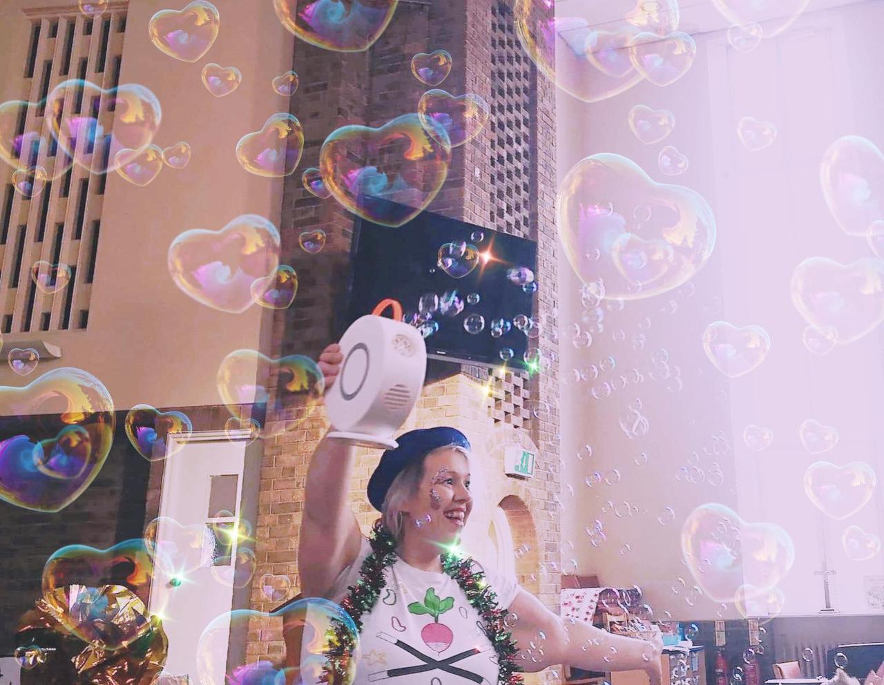 Children's wedding entertainer waving a bubble machine around