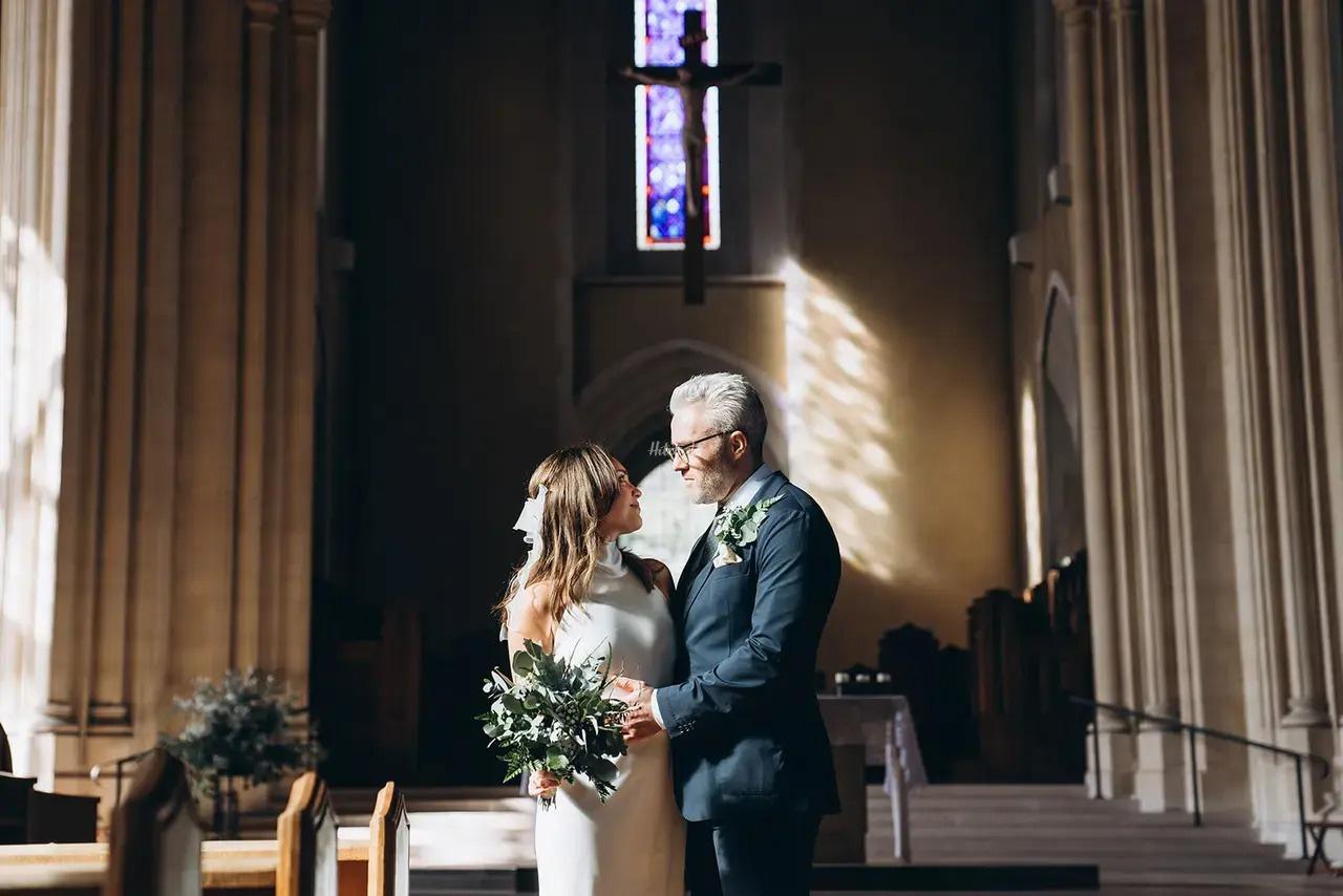 newly married couple embracing in church 