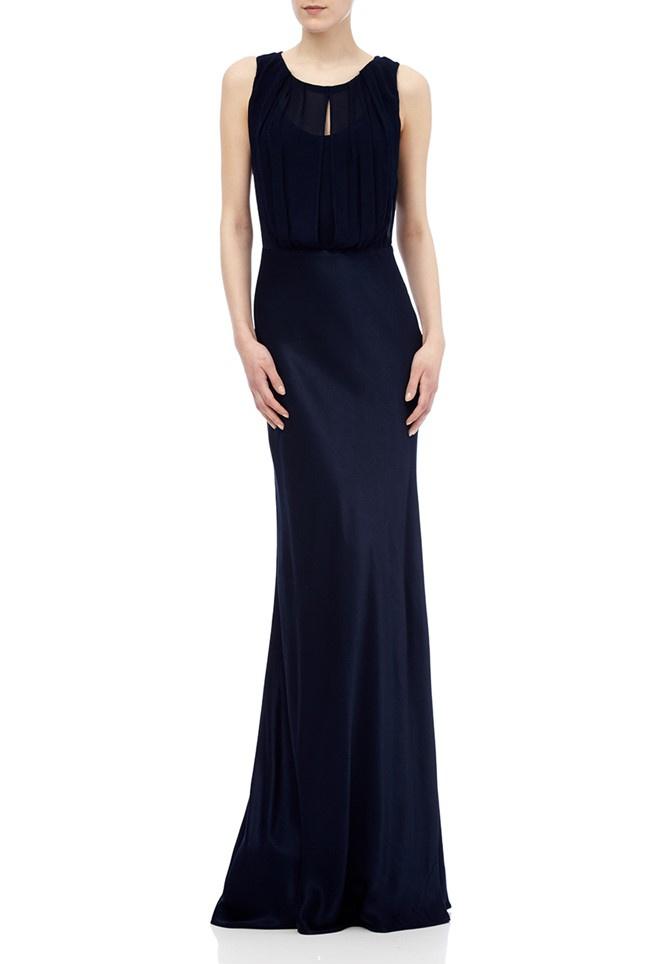 Model wearing a floor-length navy Claudia dress with draped cowl back