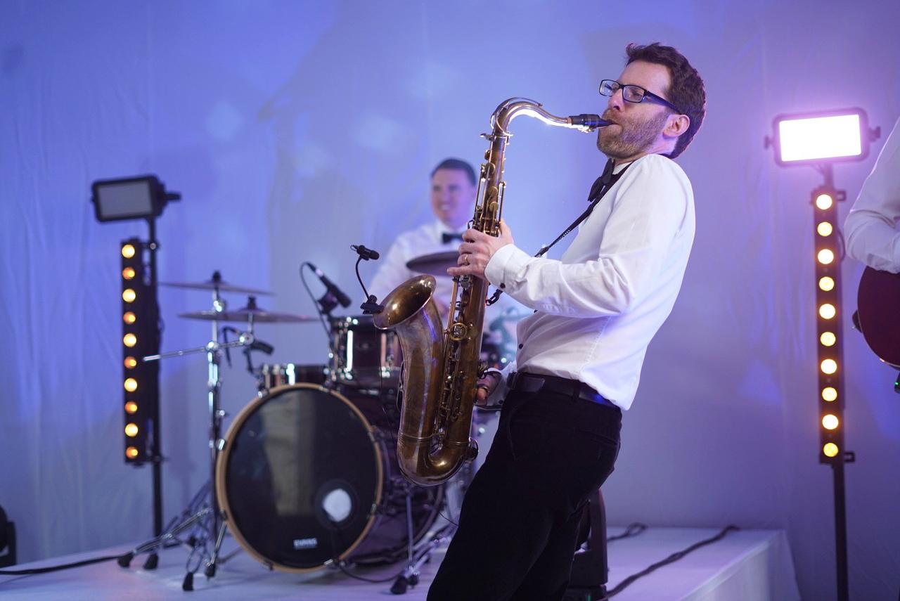 musician from It's a Vibe playing the saxophone on stage