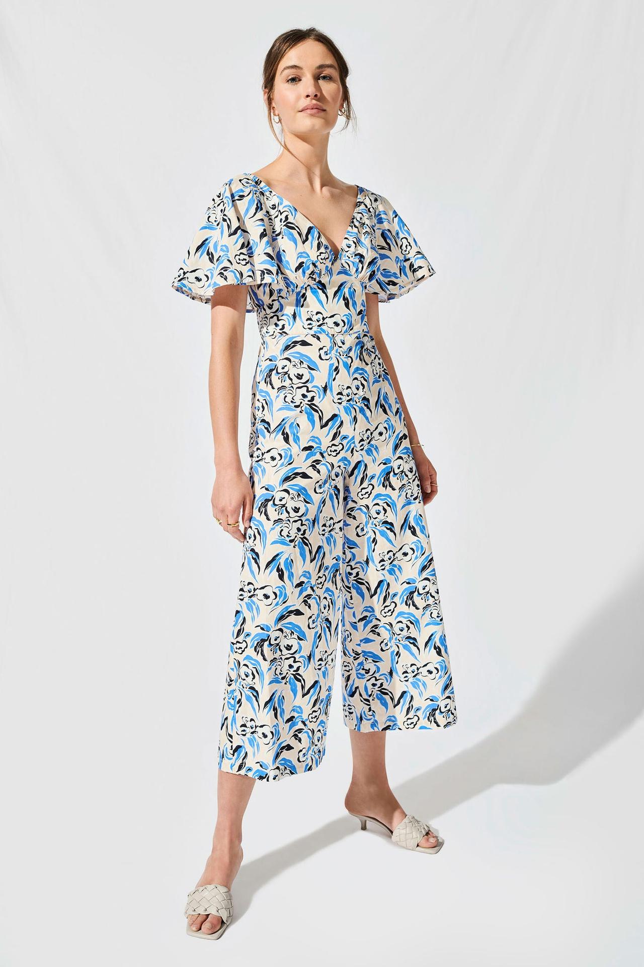 Model wearing leafy floral print cotton jumpsuit with flare sleeves