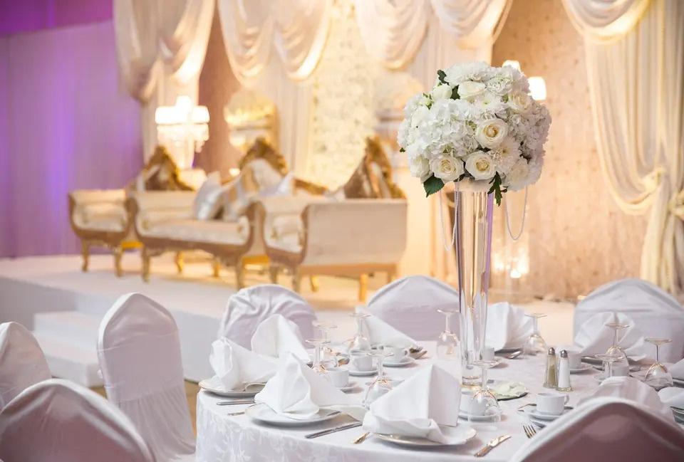 Wedding ceremony table setting with a white rose centerpiece