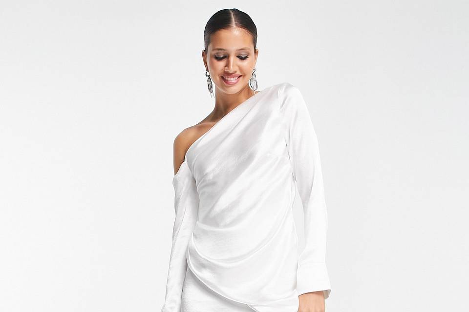 Model wearing an off the shoulder mini satin white engagement party dress