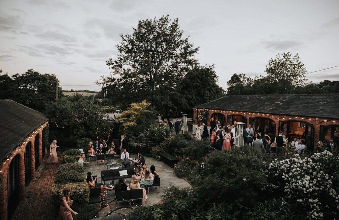 The outdoor courtyard decorated with fairylights at Dodmoor Court