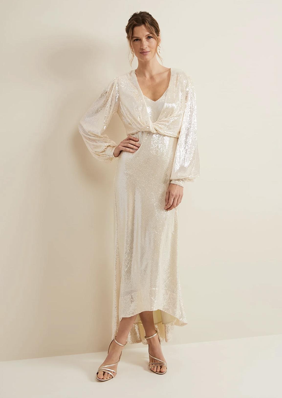 woman wearing a long sequin wraparound dress with full length balloon sleeves
