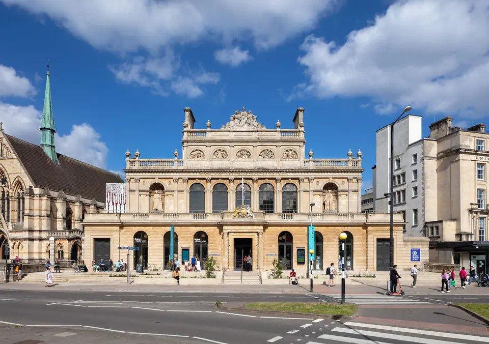 Grand three-storey sandstone building on a high street