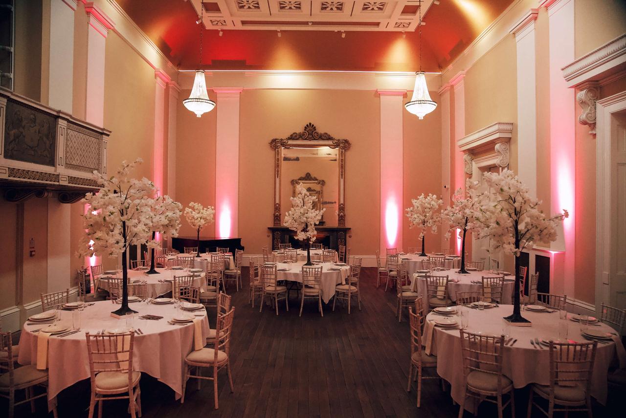 Interior of a historic hall wedding venue with LED lighting for an evening reception.