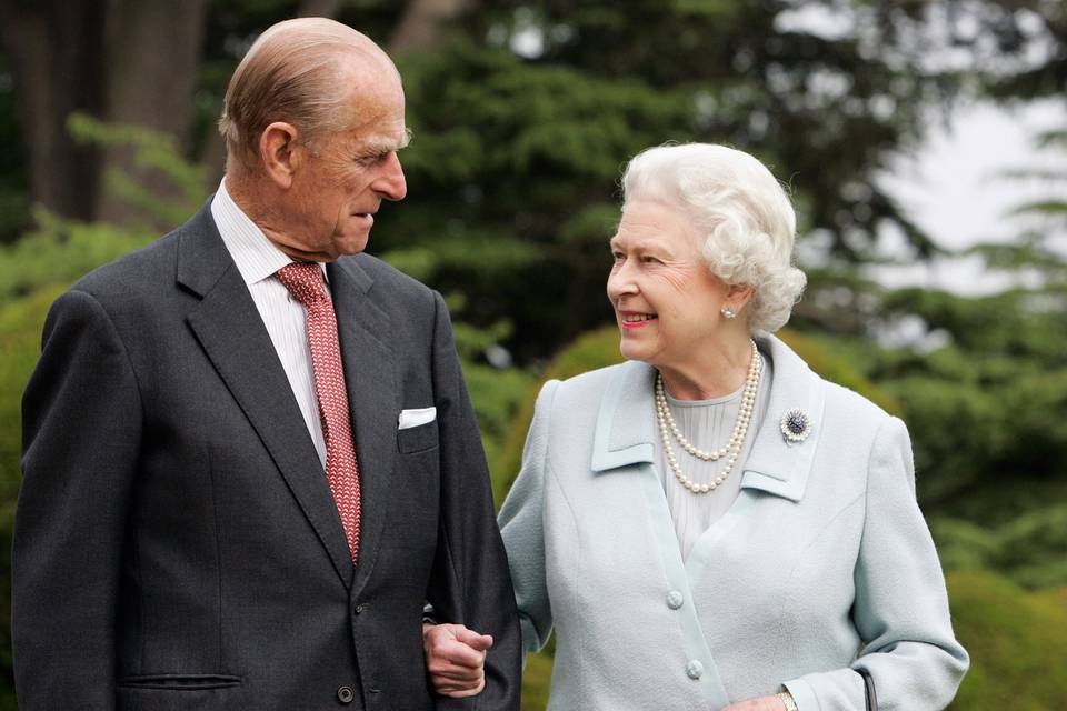 The Queen dressed in a pale blue suit linked arm in arm with Prince Philip