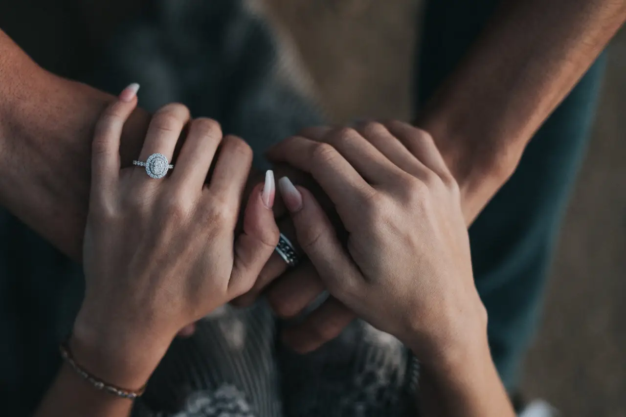 engagement ring holding hands