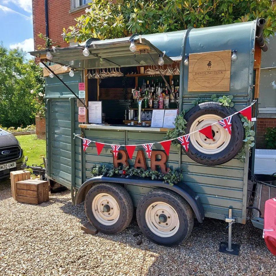 Mobile bar decorated with name sign, bunting and wooden letters spelling 