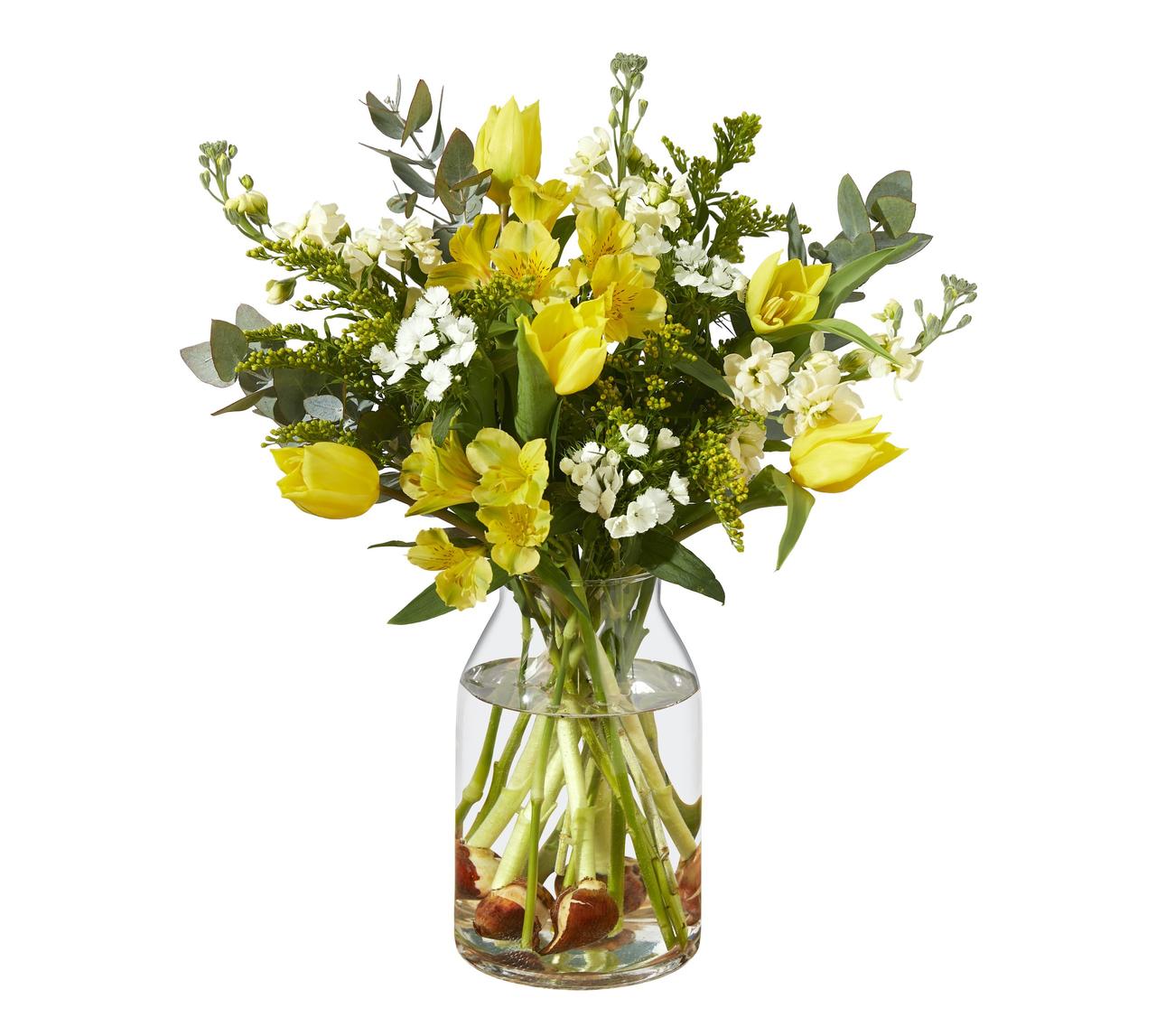 A vase of spring flowers including tulips (with bulbs attached), sweet williams, dianthus and alstroemeria.