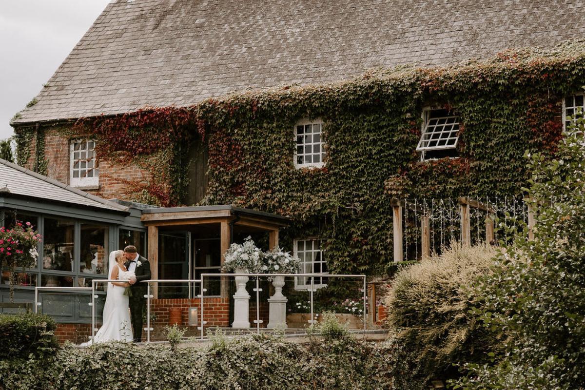a couple kissing outside the old mill in berkshire
