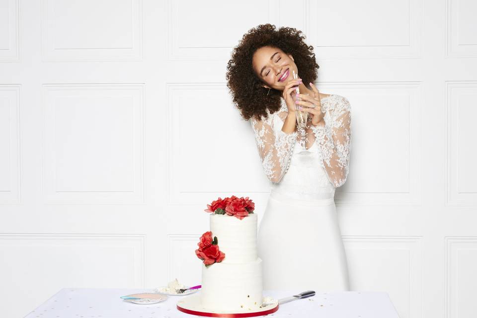 Bride smiling with her eyes closed and holding a champagne flute