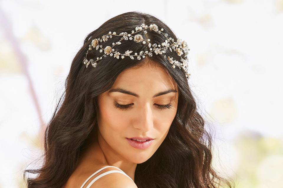 Bride with long dark hair wearing a gold and crystal hair vine