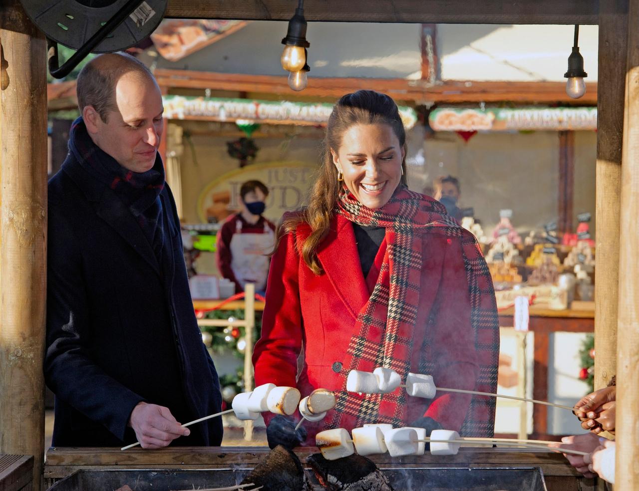 Kate Middleton and Prince William laugh as they toast marshmallows
