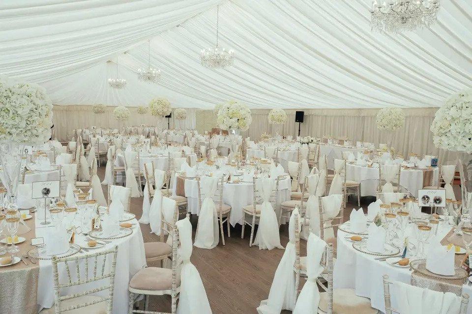 White interior marquee set for wedding breakfast at Stanbrook Abbey, Worcestershire