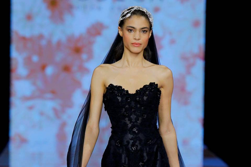 Model wearing a strapless lace black wedding dress