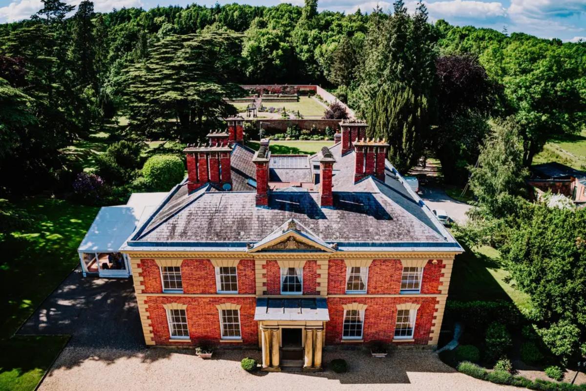 5 a birds-eye-view of red-bricked wedding venue garmyth hall where you can see the surrounding bright green verdant gardens
