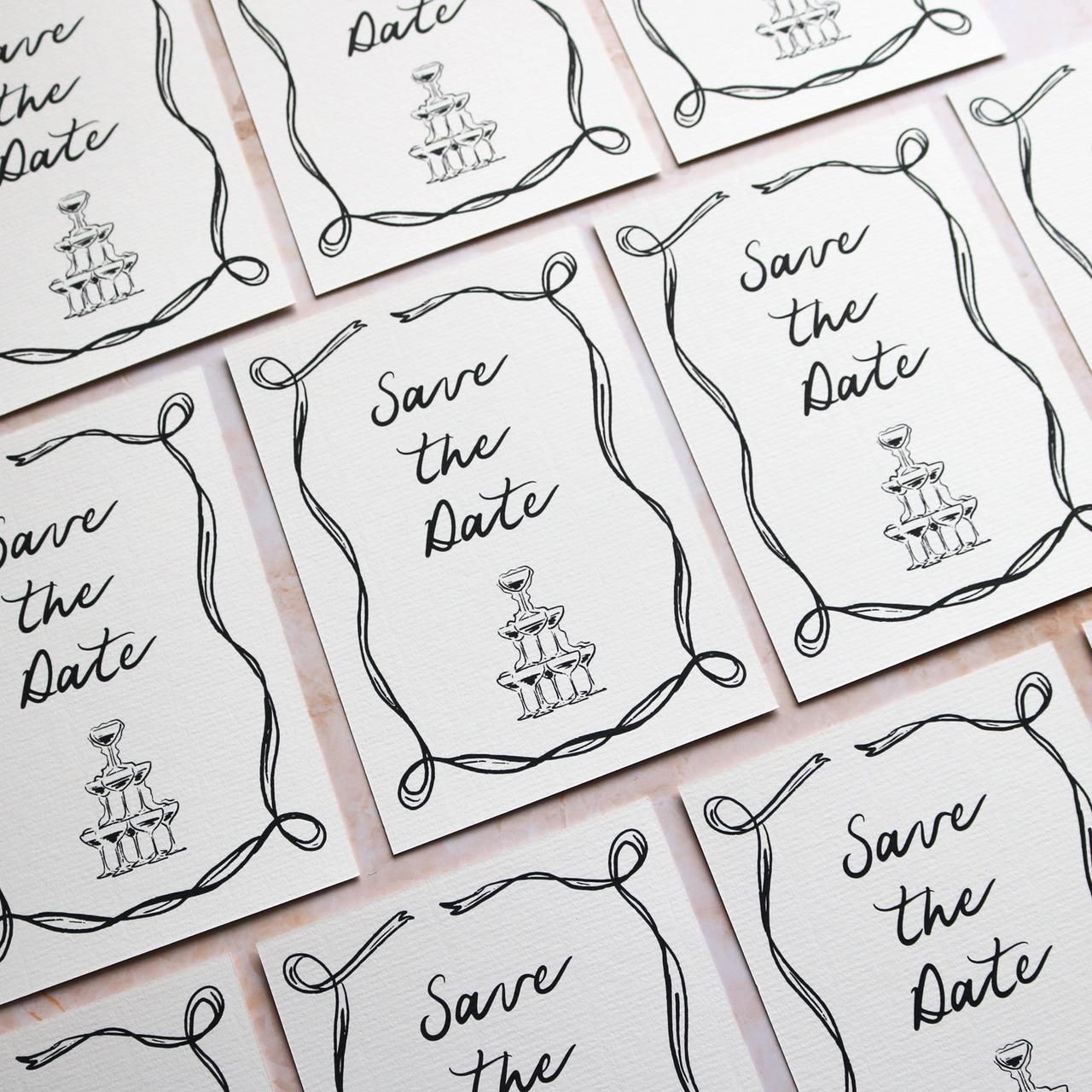 Illustrated vintage save the dates with a picture of a champagne tower on them