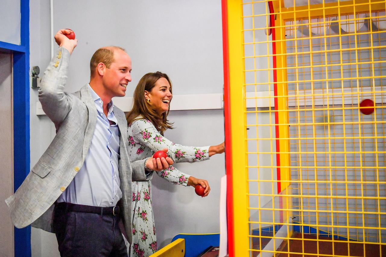 Kate Middleton and Prince William play arcade games