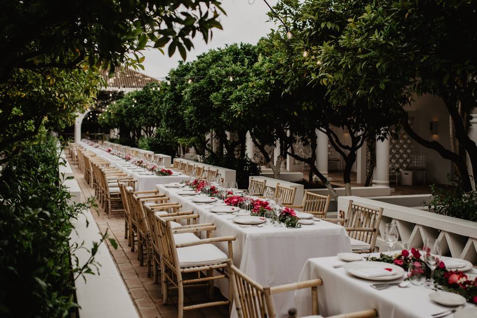 beautifully decorated long tables set up for an outdoor wedding breakfast at villa mont octant hotel