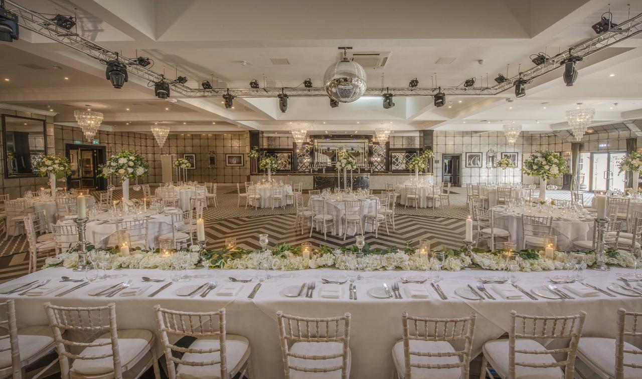 Interior of a country house hotel function space dressed for a wedding reception.