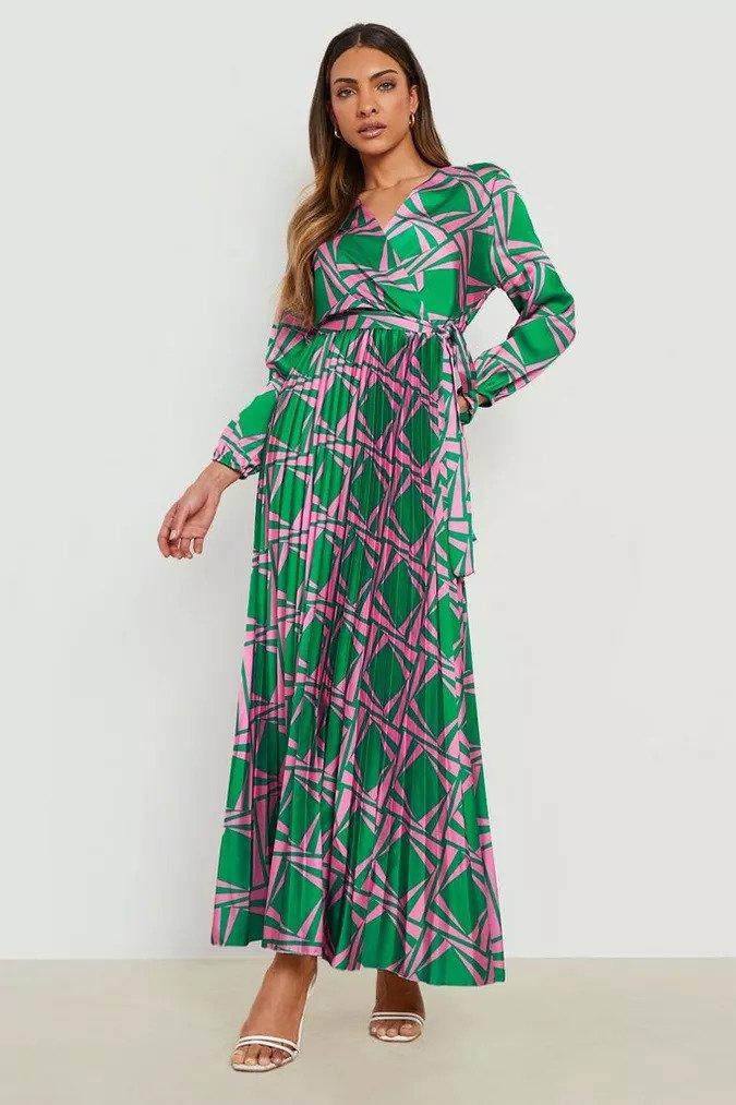 Pleated maxi dress with a wrap top and long sleeves with a pink and green aztec print pattern