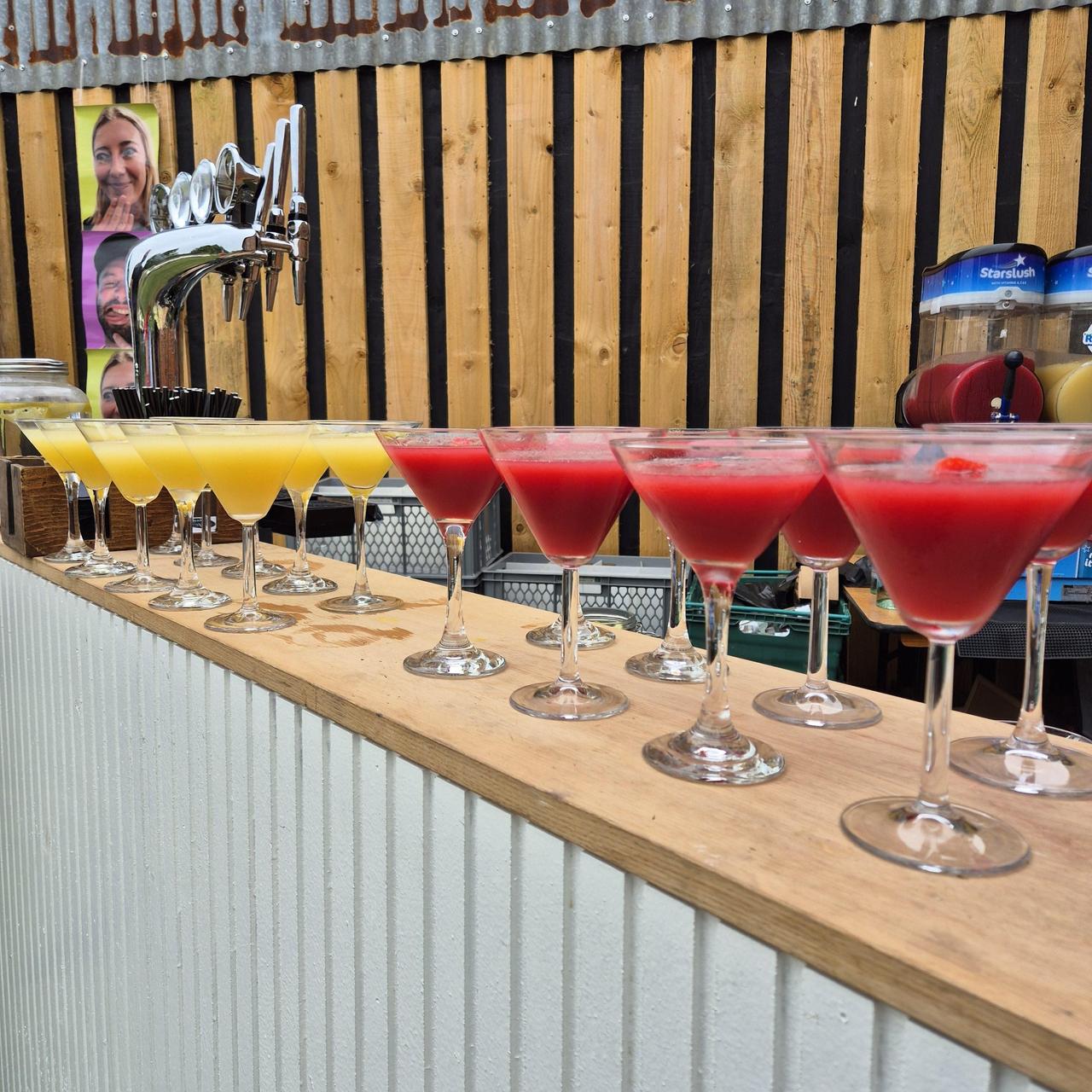 frozen cocktails lined up on a bar at a wedding