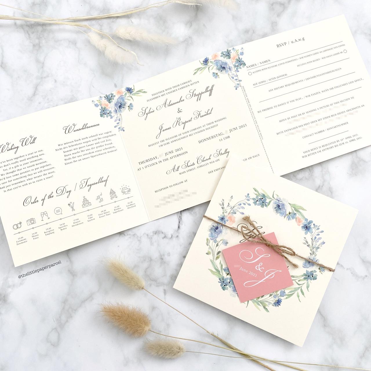 Pale pink and blue floral vintage wedding invitation secured with rustic twine