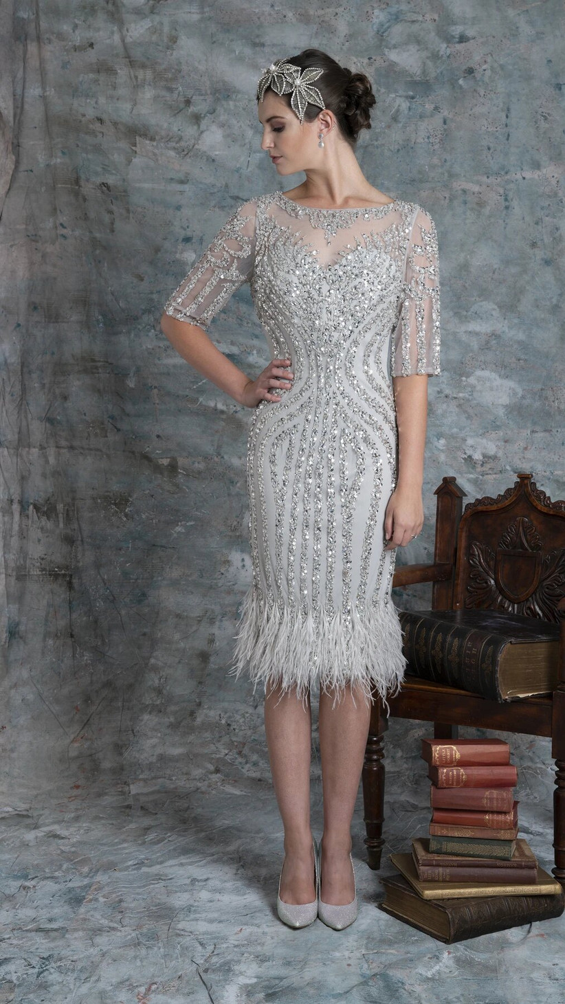 Girl wearing a silver sequin and feather midi dress