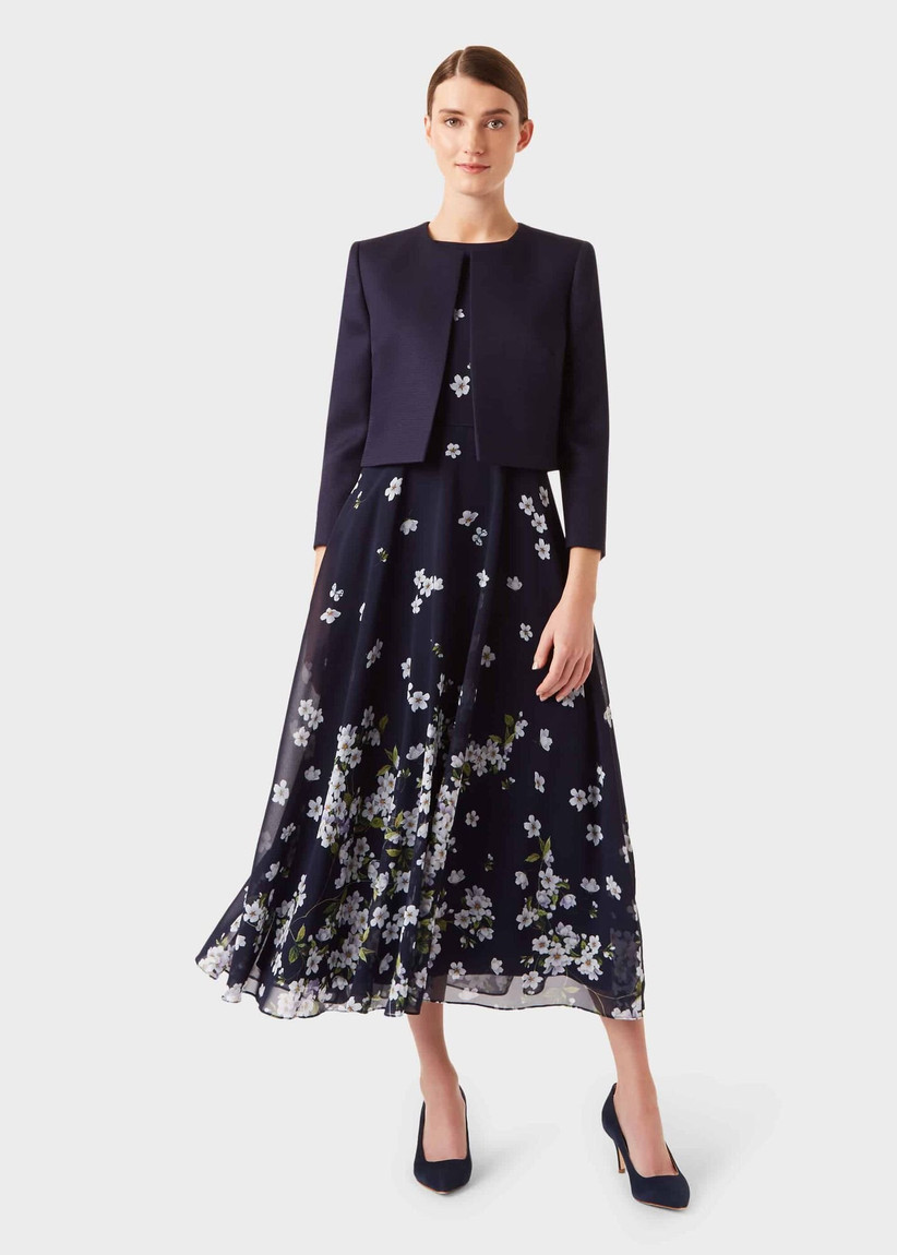 Navy dress with white flowers with a cropped navy jacket