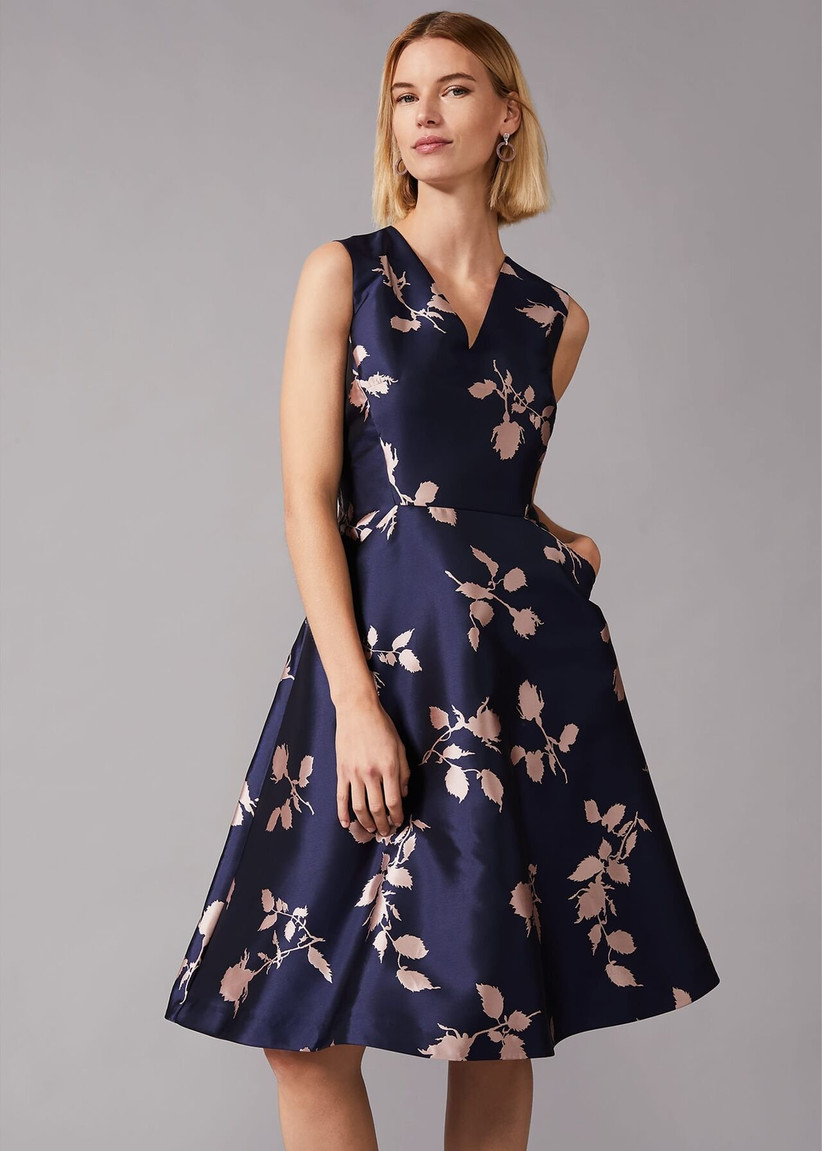 Girl wearing a full navy dress with pale pink flowers