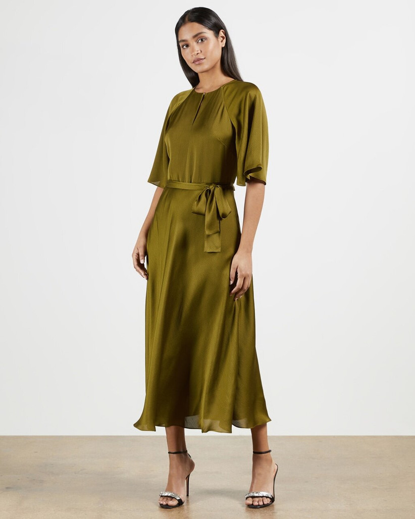 Girl wearing an olive green satin tea midi dress