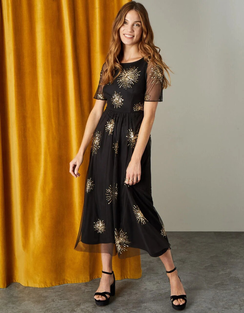 Model wearing an embellished mother of the groom dress