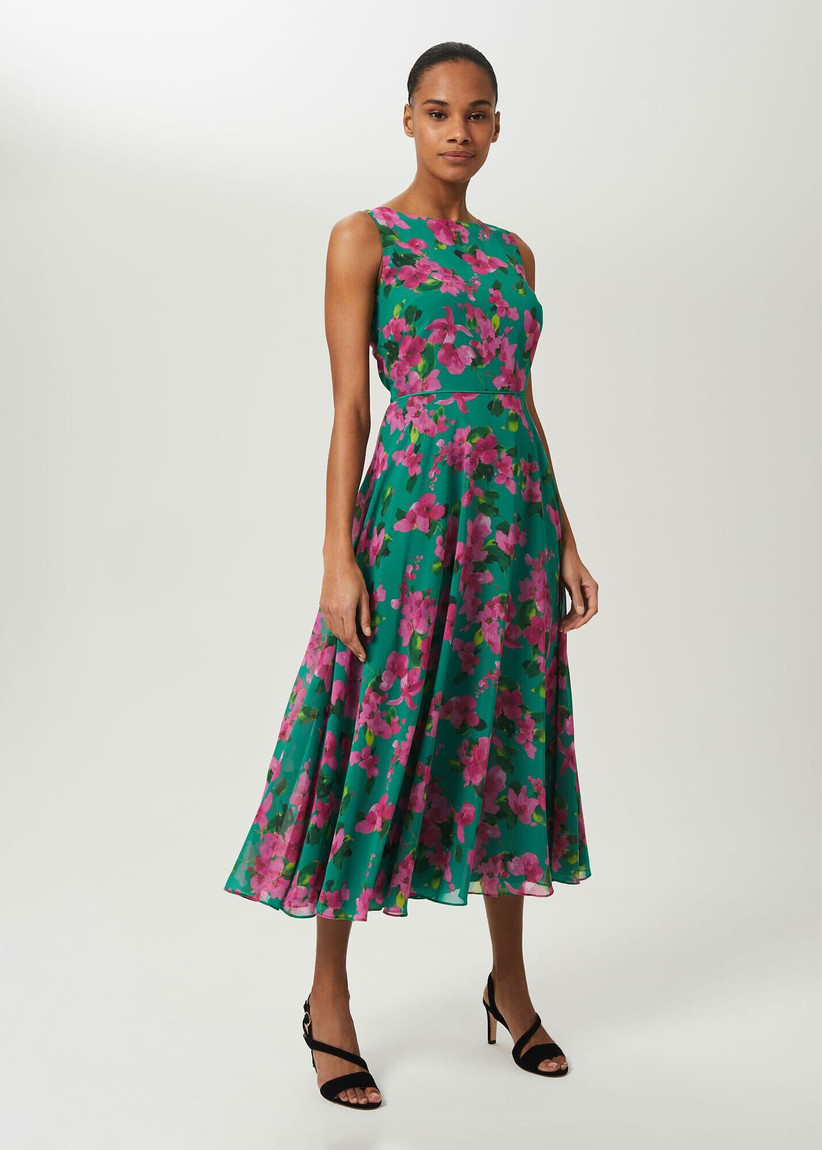 Girl with a sleeveless green dress with pink floral pattern