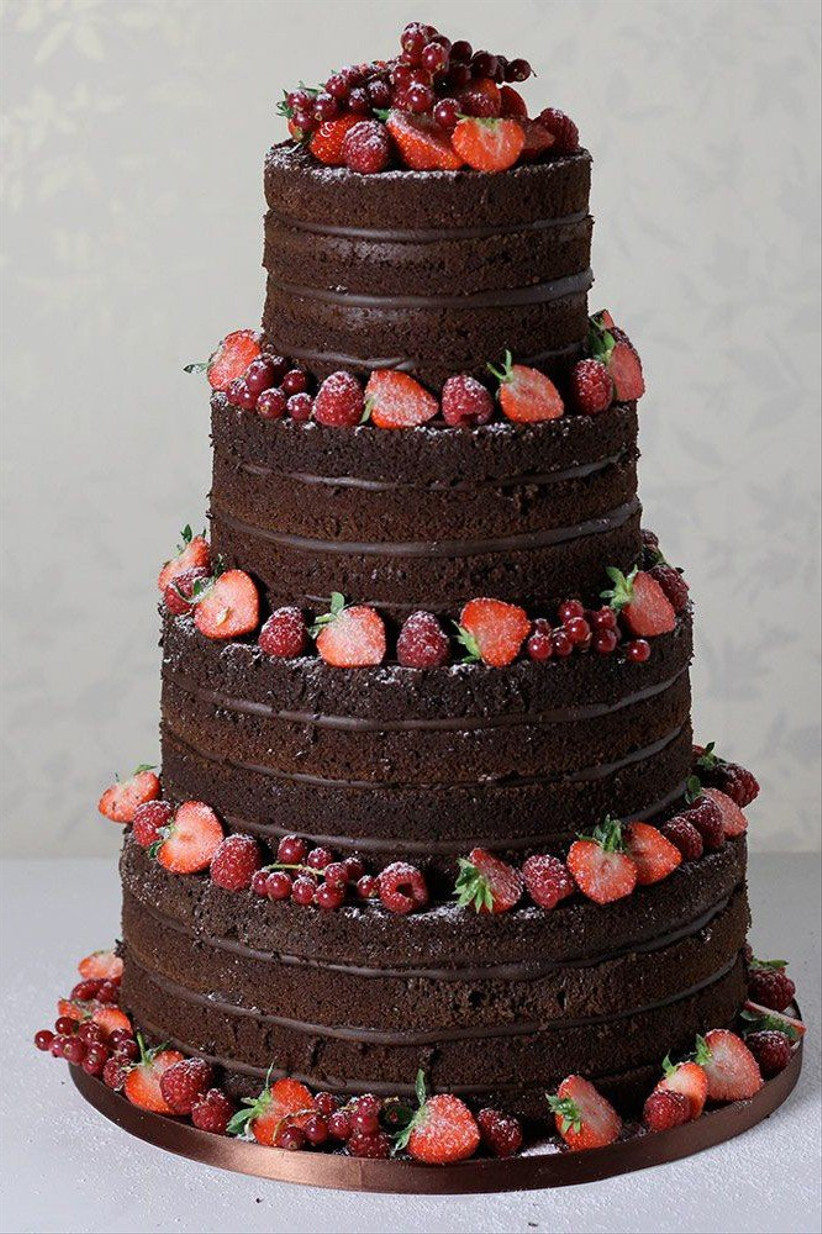 a-chocolate-cake-topped-with-raspberries-and-flowers