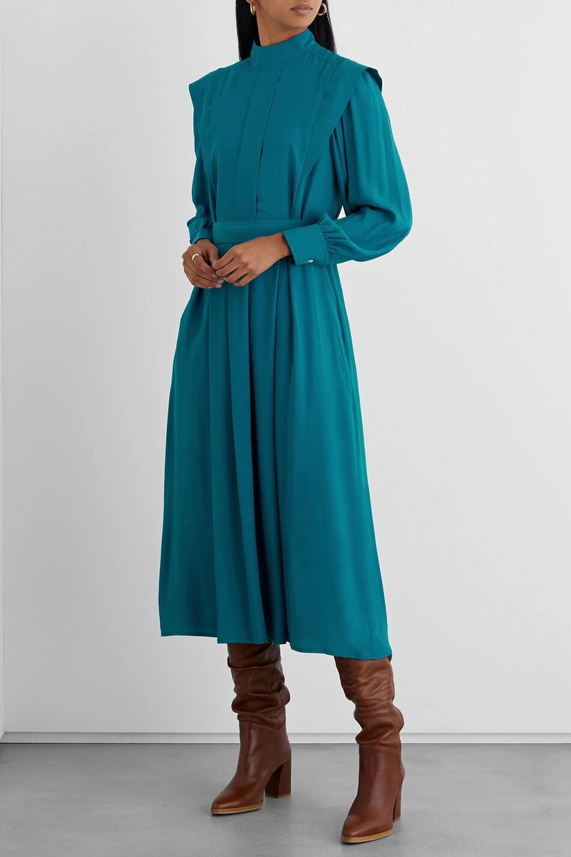 Model wearing a pleated teal midi dress