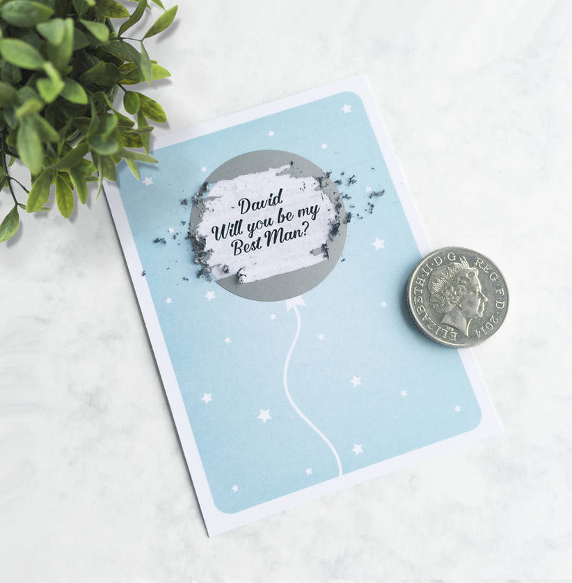 Pale blue card with a scratch off silver balloon and personalised message asking will you be my best man