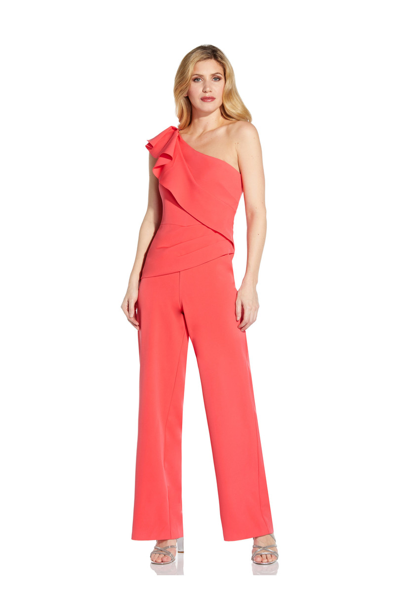 Girl wearing a coral jumpsuit with a ruffle shoulder