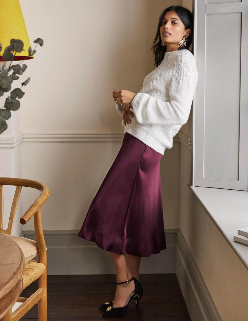 Model wearing a burgundy mother of the groom skirt