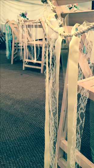 Pastel ribbon and lace chair decorations, paper lanterns and other lovely wedding bits
